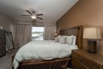 BEDROOM 1 MASTER KING BED SUITE WITH WALKOUT DOORS TO THE BEAUTIFUL LAKE VIEWS & CURTAINS FOR PRIVACY WHEN NEEDED